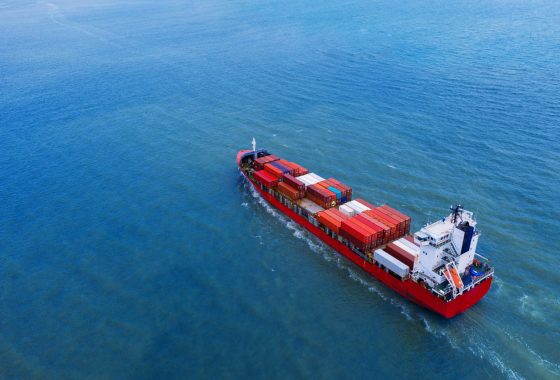 Aerial view of container cargo ship in sea.